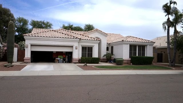 A garage door closes automatically on a home in a typical Phoenix neighborhood.  	