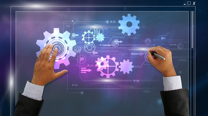 Hand drawing gears on circuit board. success concept