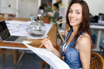 Young woman standing in creative office