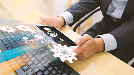 Businessman using tablet and computer. © fgnopporn
