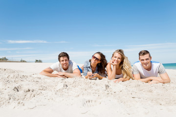 Fototapeta premium Company of young people on the beach