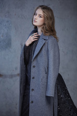 A woman in a grey coat.