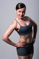 Fototapeta na wymiar Portrait of athletic brunette. Fitness woman on a light background