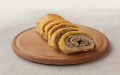 Egg rolls with cheese cream  and meaton a cutting boardh