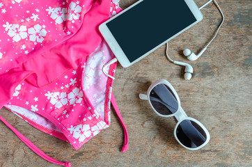 Swimsuit  smartphone and sunglasses