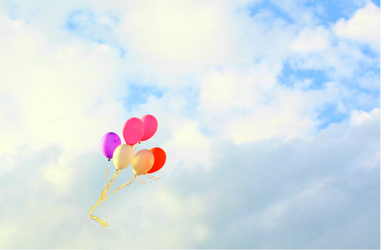 The colorful balloons with blue sky background, concept of love in summer and valentine, wedding. Selective focus on the balloons