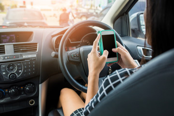 Naklejka premium Woman using smartphone during driving a car. Vintage