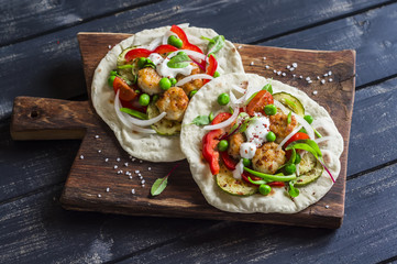 Chicken meatballs and fresh vegetables tacos. Healthy delicious breakfast or snack. On wooden rustic board