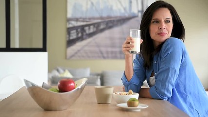 Portrait of mature woman drinking milk - Powered by Adobe