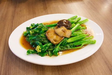 Stir-fried chinese broccoli and shiitake mushroom in oyster sauc