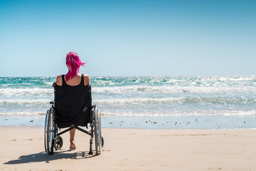 Disabled woman in the wheelchair - Powered by Adobe