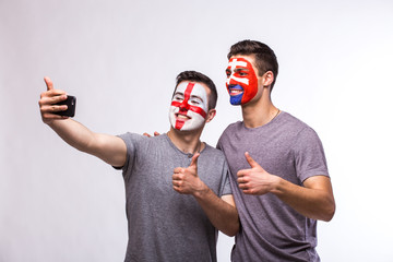 England vs Slovakia football fans take selfie photo with phone on white background. European football fans concept.