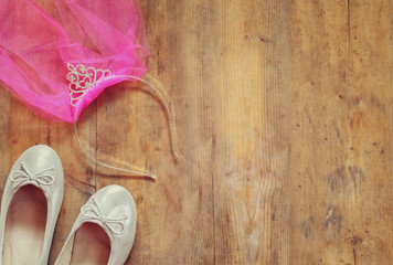 girl's diamond tiara with pink chiffon vail next to ballet shoes © tomertu