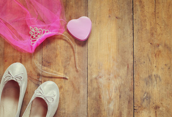 girl's tiara with chiffon vail, ballet shoes on wooden table © tomertu