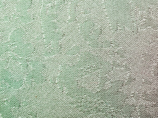 textile background - green batik silk fabric