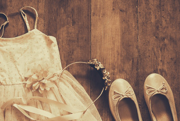 vintage chiffon girl's dress, floral tiara next to ballet shoes © tomertu