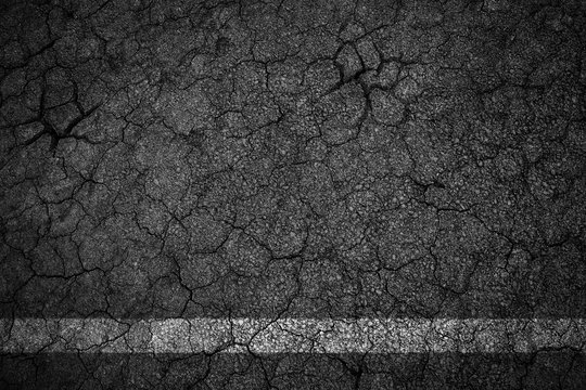 Old crack asphalt road with white lines