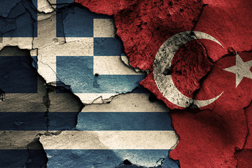 flags of Greece and Turkey painted on cracked wall