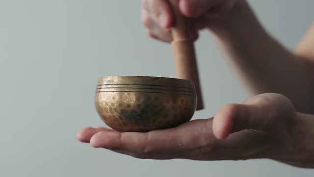 Small Tibetan Singing Bowl Being Made to Sing in Ones Hand.