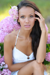 portrait of a beautiful girl with flowers in the summer