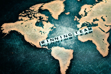 WINNING TEAM on grunge world map