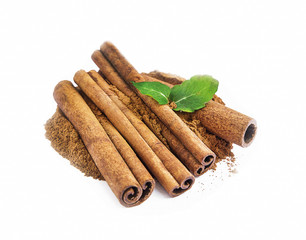 Ground cinnamon and sticks isolated
