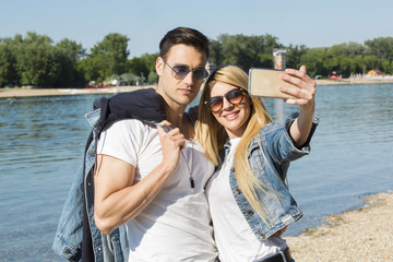 Couple taking selfie at the beach