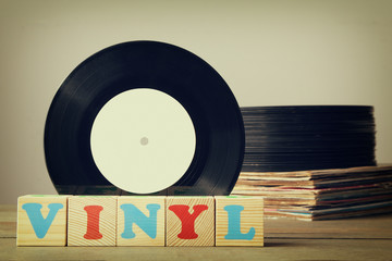 vinyl record collection on wooden background with wooden cubes