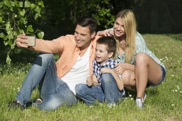 Naklejka na ściany i meble Happy family outdoors on a sunny day