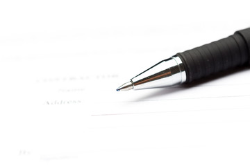 Close-up of pen on contract
