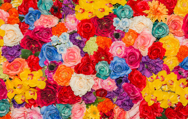 Fototapeta na wymiar Beautiful multicolored artificial flowers background.