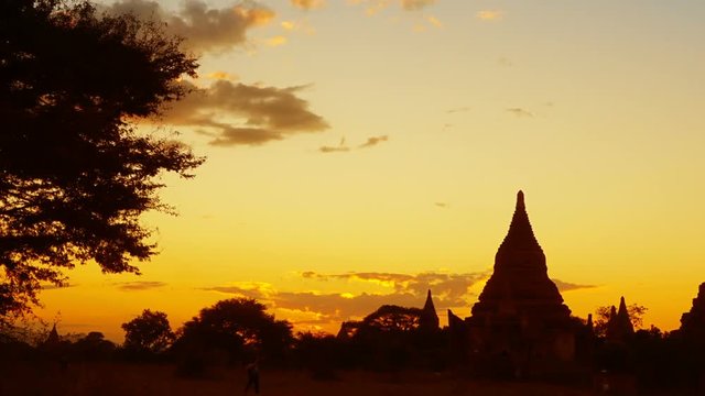 Silhouette of Temples and tree in Bagan at sunset, Myanmar (Burma), zoom timelapse
