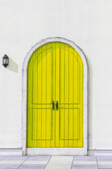 Colorful wooden yellow door and Detail of house exterior