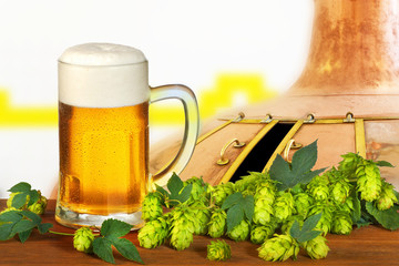 glass of beer with hops in the brewery