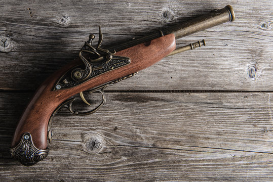 old pistol  on the wooden board
