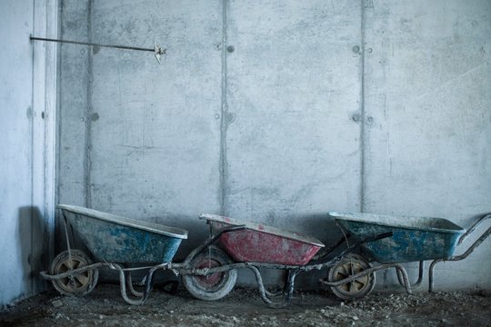 Row of three wheelbarrows on construction site