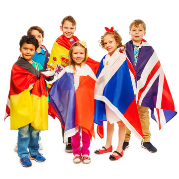 Six kids wrapped in flags of European nations