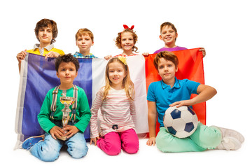Group of little football fans holding French flag