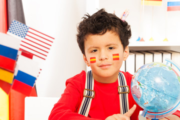 Schoolboy with Spanish flag painted on his cheeks