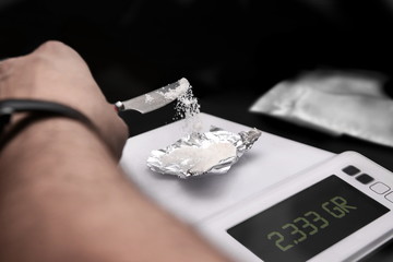 drug dealer preparing dose to sell in illegal lab
