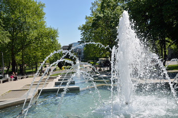 Lush fountain in city park on spring day