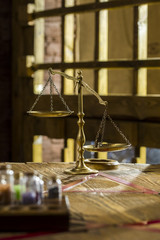 bronze hand weights on a wooden table against the background of the lattice