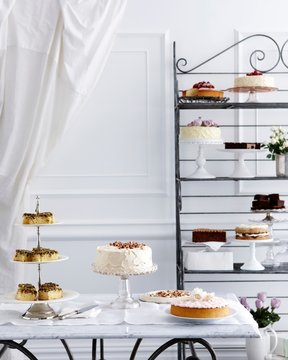 Selection of cakes on traditional tea table and stand