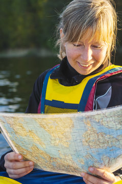 Mature woman reading map
