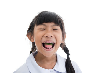 Obraz na płótnie Canvas Cute Asian girl in uniform showing her broken teeth on white bac