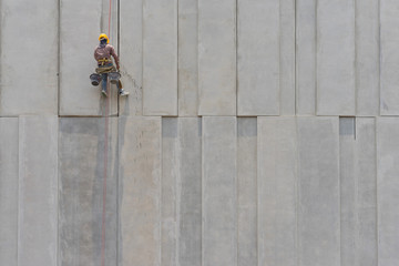 Construction worker and grey cement wall