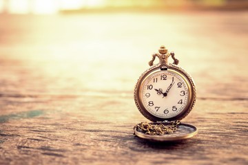 vintage pocket watch on grunge wood log