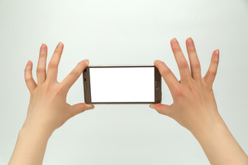 Big smartphone with empty blank display in hands isolated on the white background
