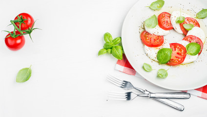 CLassic Italian Caprese salad with tomatoes, mozzarella di Buffala and fresh basil.