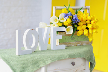 Interior decoration elements with vintage table, love letters and spring flowers bouquet